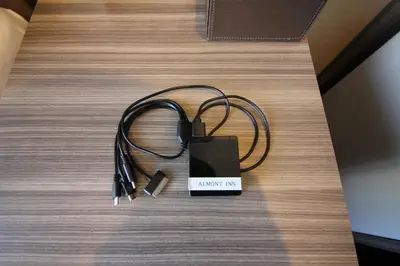a charger on top of a table with aether at Almont Inn Tokyo Nihonbashi in Tokyo