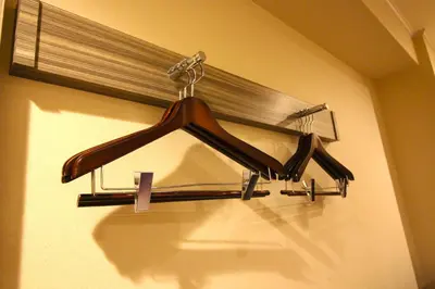 a rack of hangers in a room at Almont Inn Tokyo Nihonbashi in Tokyo