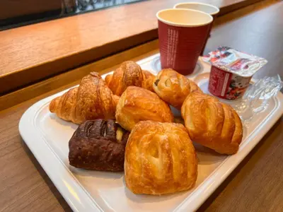 a plate of pastries on a table with a cup of coffee at Almont Inn Tokyo Nihonbashi in Tokyo