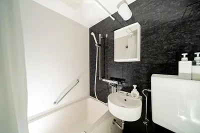 a bathroom with a white sink and a mirror at K&K Apartment Kita-Akabane #202 in Tokyo