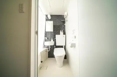 a white bathroom with a toilet and a sink at K&K Apartment Kita-Akabane #202 in Tokyo