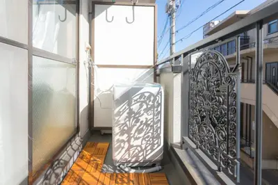 a balcony with an iron gate and a door at K&K Apartment Kita-Akabane #202 in Tokyo