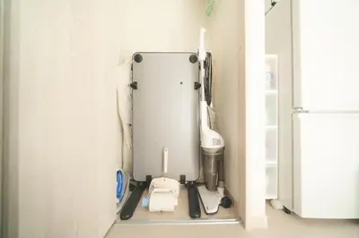 a kitchen with a appliance in the corner of a room at K&K Apartment Kita-Akabane #202 in Tokyo