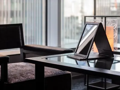 a laptop computer sitting on a table with chairs at Mitsui Garden Hotel Nihonbashi Premier in Tokyo