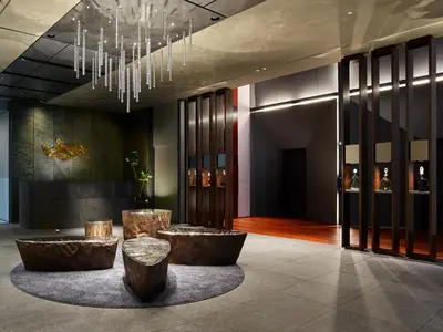 a lobby with two tables and a chandelier at Mitsui Garden Hotel Nihonbashi Premier in Tokyo