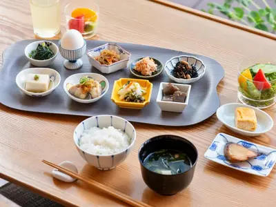 a tray of food on a table with bowls of food at Mitsui Garden Hotel Nihonbashi Premier in Tokyo