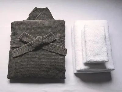 a towel and a napkin with a bow on it at Apartment Hotel Shinjuku in Tokyo