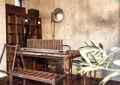 an old wooden table with a chair and a lamp at Apartment Hotel Shinjuku in Tokyo