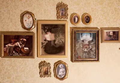 a wall with a bunch of pictures on it at Apartment Hotel Shinjuku in Tokyo