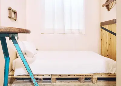 a bedroom with a bed on a wooden ladder at Apartment Hotel Shinjuku in Tokyo