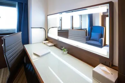 a train room with a desk and a mirror at Hotel Bellclassic Tokyo in Tokyo