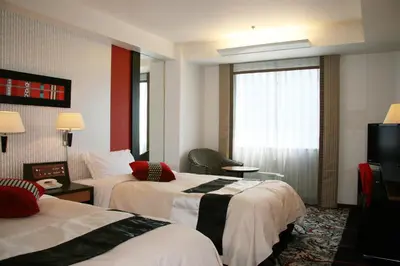 a hotel room with two beds and a window at New Otani Inn Tokyo in Tokyo