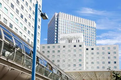 a tall building with a train in front of it at New Otani Inn Tokyo in Tokyo