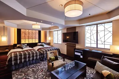 a hotel room with two beds and a television at New Otani Inn Tokyo in Tokyo