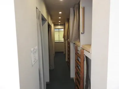 a hallway in a house with a hallway leading into a room at bnb+ Secret Base Mejiro in Tokyo