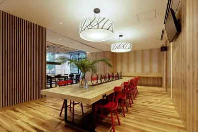 a long table in a room with red chairs at the b asakusa in Tokyo