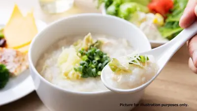 a person is eating a bowl of rice with a spoon at the b asakusa in Tokyo