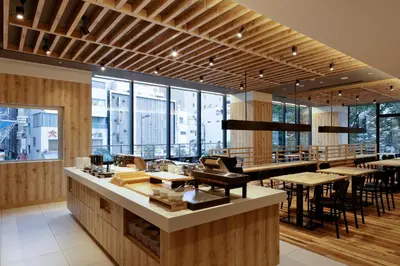 a restaurant with tables and chairs and windows at the b asakusa in Tokyo