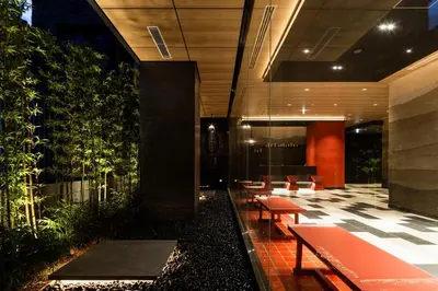a lobby with a row of benches and plants at the b asakusa in Tokyo