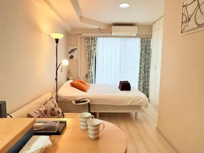a small room with a bed and a dog in it at Shimokitazawa Independent Apartment in Tokyo