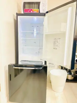 a refrigerator with its door open in a kitchen at Shimokitazawa Independent Apartment in Tokyo