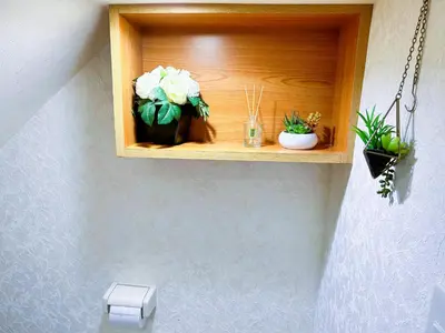 a shelf with potted plants on a wall at yikebukuro LuckyHouse \u6c60\u888b\u4e00\u8ed2\u5bb6 \u5e78\u904b\u306e\u5bb6 in Tokyo