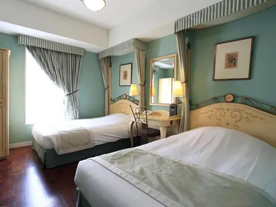 a hotel room with two beds and a mirror at Hotel Monterey Lasoeur Ginza in Tokyo