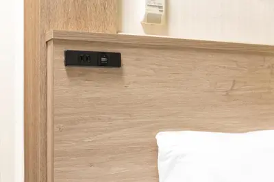 a close up of a wooden door of a bed at Washington R&B Hotel Higashi Nihonbashi in Tokyo