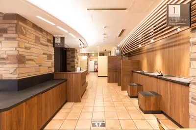 a lobby of a restaurant with a stone wall at Washington R&B Hotel Higashi Nihonbashi in Tokyo