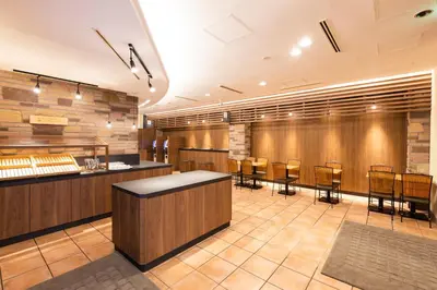 a restaurant with a counter and chairs in a room at Washington R&B Hotel Higashi Nihonbashi in Tokyo