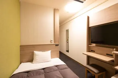 a hotel room with a bed and a flat screen tv at Washington R&B Hotel Higashi Nihonbashi in Tokyo