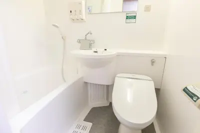 a white bathroom with a toilet and a sink at Washington R&B Hotel Higashi Nihonbashi in Tokyo