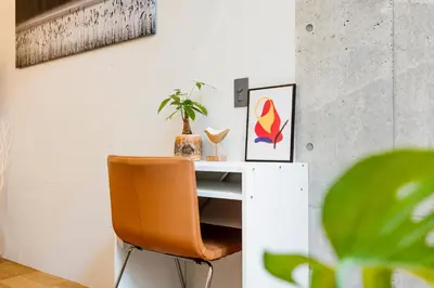 an orange chair sitting next to a white desk at RiriLeo Koenji in Tokyo