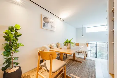 a dining room with a table and a couch at RiriLeo Koenji in Tokyo