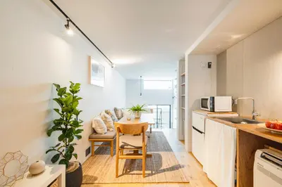 a kitchen and dining room with a table and chairs at RiriLeo Koenji in Tokyo