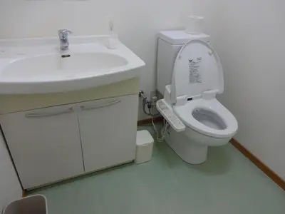 a white bathroom with a sink and a toilet at Hotel Meigetsu in Tokyo