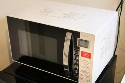 a microwave with a box on top of it at Bay Hotel Urayasu-ekimae in Urayasu