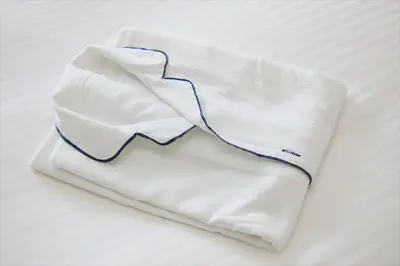 a white sock with a blue stripe on a bed at Bay Hotel Urayasu-ekimae in Urayasu