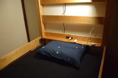 a bunk bed with a blue pillow in a room at Guest house SHIE SHIMI in Tokyo