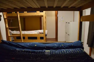 a room with two bunk beds and a couch at Guest house SHIE SHIMI in Tokyo