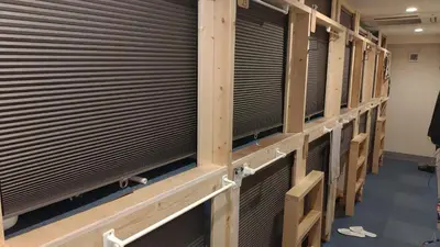 a row of venetian blinds in a baseball dugout at Base Inn Uguisudani in Tokyo
