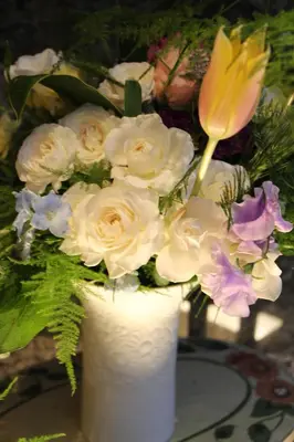 a white vase filled with white flowers on a table at Hotel Apio in Tokyo