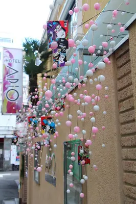 a bunch of pink and white balloons hanging from a building at Hotel Apio in Tokyo
