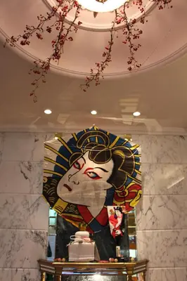 a large painting of a woman on a wall at Hotel Apio in Tokyo