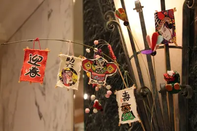 a bunch of tags hanging from a pole at Hotel Apio in Tokyo