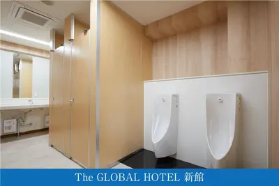 a bathroom with two urinals on the wall at The Global Hotel Tokyo in Tokyo