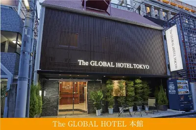 a building with a sign that reads the global hotel lodge at The Global Hotel Tokyo in Tokyo