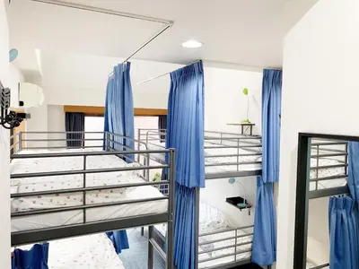 a bunk bed in a room with blue drapes at Akasakano-sato(Premium) in Tokyo