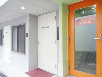 an office corridor with an orange door and a sign at Akasakano-sato(Premium) in Tokyo