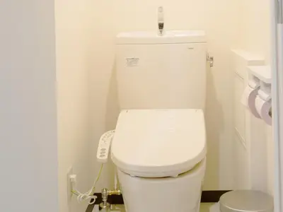 a white toilet in a bathroom with a remote control at Akasakano-sato(Premium) in Tokyo